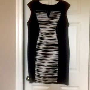 This can be worn as a formal dress. Nearly new. Rich detail in strips on front.